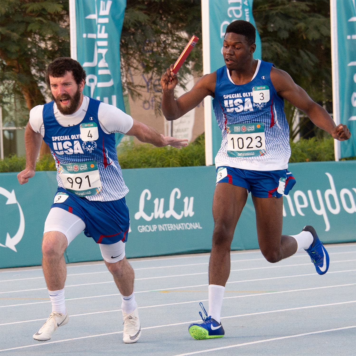 Chris Tucker (right) competes in a track and field relay at the 2019 World Games
